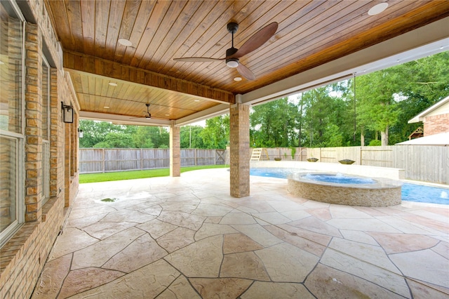 18511 Yellowstone Trl, Humble, TX 77346 - fenced backyard with a ceiling fan, a pool with connected hot tub, and a patio