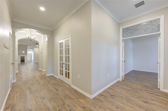 18511 Yellowstone Trl, Humble, TX 77346 - corridor featuring arched walkways, ornate columns, wood finished floors, ornamental molding, and recessed lighting