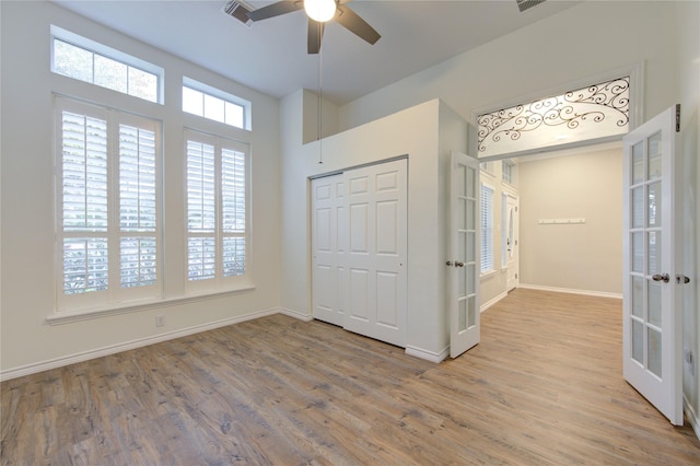 18511 Yellowstone Trl, Humble, TX 77346 - unfurnished bedroom featuring french doors, wood finished floors, a closet, and a ceiling fan