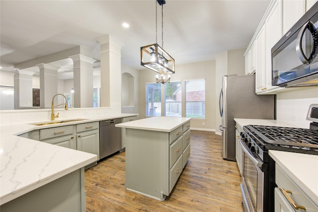 18511 Yellowstone Trl, Humble, TX 77346 - kitchen featuring appliances with stainless steel finishes, a center island, tasteful backsplash, light wood-style floors, and recessed lighting