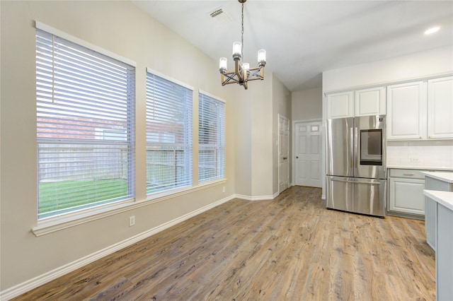 18511 Yellowstone Trl, Humble, TX 77346 - kitchen featuring smart refrigerator, a chandelier, light countertops, and healthy amount of natural light