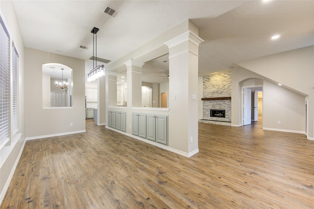 18511 Yellowstone Trl, Humble, TX 77346 - unfurnished living room with light wood-style flooring, a fireplace, a ceiling fan, a chandelier, and recessed lighting