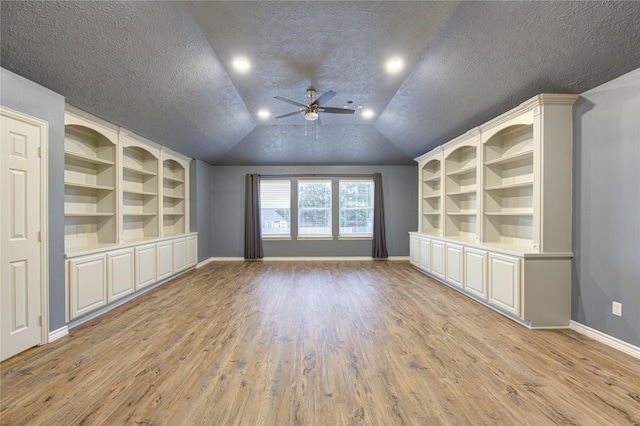 18511 Yellowstone Trl, Humble, TX 77346 - unfurnished room with a ceiling fan, light wood-style floors, built in features, a textured ceiling, and vaulted ceiling