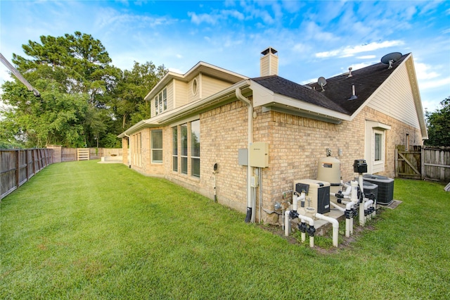 18511 Yellowstone Trl, Humble, TX 77346 - rear view of house with a chimney, brick siding, and a fenced backyard
