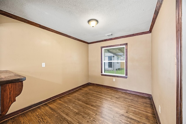 5419 Firefly Ave, Houston, TX 77017 - empty room with dark wood-style flooring, a textured ceiling, and ornamental molding