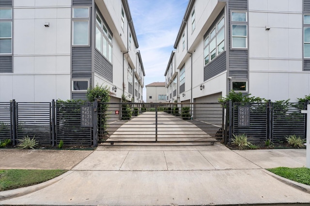 9635 Riddlewood Ln, Houston, TX 77025 - view of concrete driveway with a gate