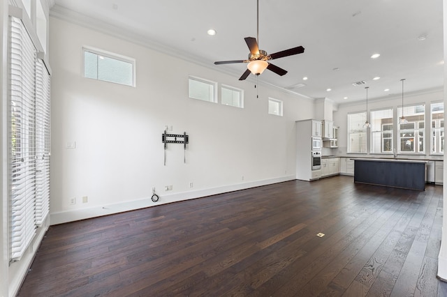 9635 Riddlewood Ln, Houston, TX 77025 - unfurnished living room featuring ornamental molding, a ceiling fan, plenty of natural light, dark wood-style flooring, and recessed lighting