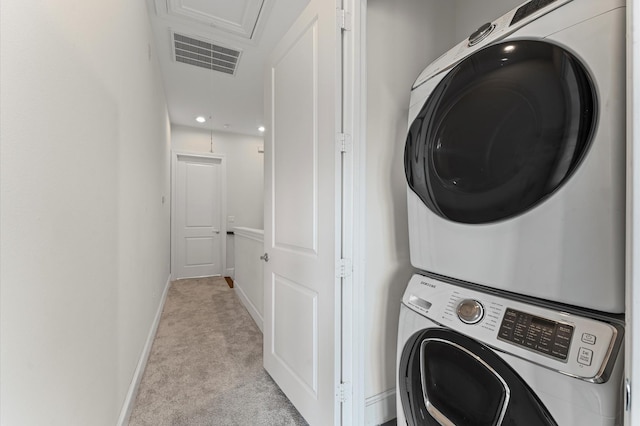 9635 Riddlewood Ln, Houston, TX 77025 - laundry room featuring attic access, stacked washer / drying machine, and light colored carpet