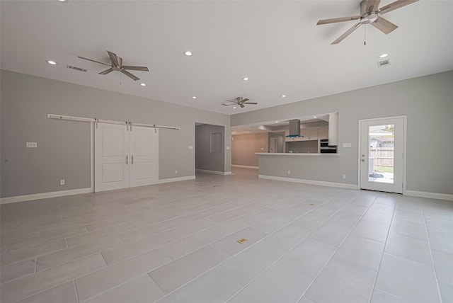 4414 Lemac Dr, Houston, TX 77096 - unfurnished living room featuring a barn door, ceiling fan, and recessed lighting