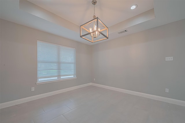 4414 Lemac Dr, Houston, TX 77096 - empty room featuring a chandelier, a raised ceiling, and light tile patterned floors