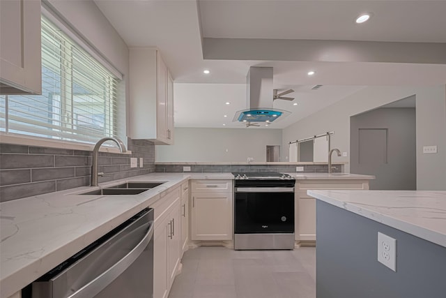4414 Lemac Dr, Houston, TX 77096 - kitchen with appliances with stainless steel finishes, light stone counters, tasteful backsplash, island exhaust hood, and recessed lighting