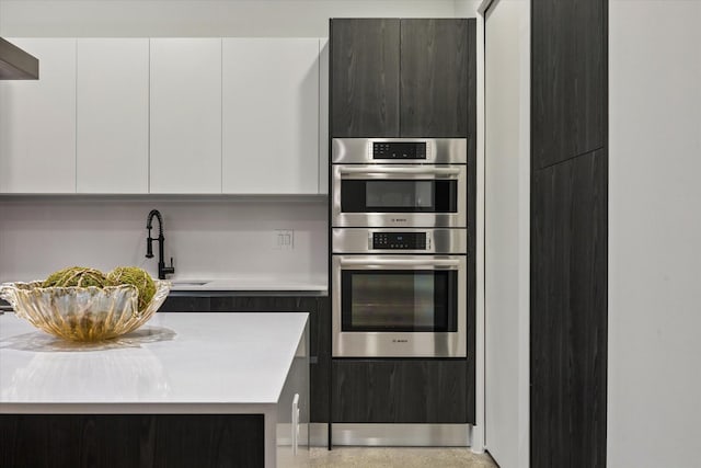 2014 Colquitt, Houston, TX 77098 - kitchen with modern cabinets, double oven, light countertops, and white cabinetry