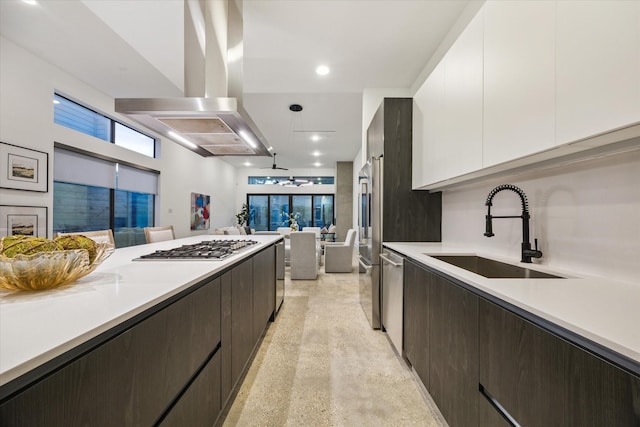 2014 Colquitt, Houston, TX 77098 - kitchen featuring exhaust hood, open floor plan, white cabinets, stainless steel gas cooktop, and dark brown cabinets