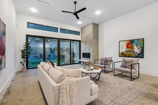 2014 Colquitt, Houston, TX 77098 - living room featuring finished concrete floors, a ceiling fan, a large fireplace, recessed lighting, and a high ceiling
