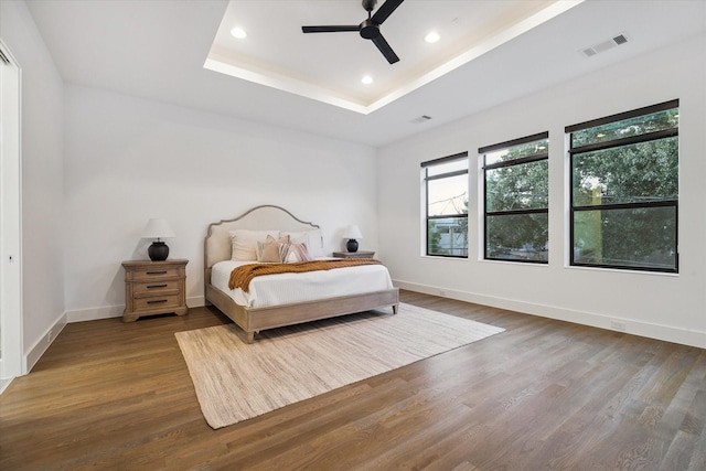 2014 Colquitt, Houston, TX 77098 - bedroom with wood finished floors, a tray ceiling, recessed lighting, and ceiling fan