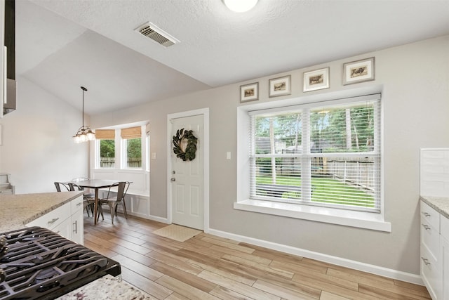 79 Fallshire Dr, The Woodlands, TX 77381 - entryway featuring light wood-style flooring, lofted ceiling, and a chandelier