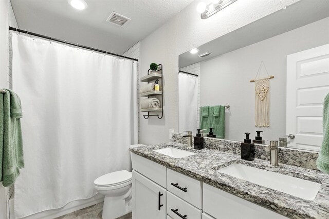 79 Fallshire Dr, The Woodlands, TX 77381 - bathroom featuring double vanity and a shower with shower curtain