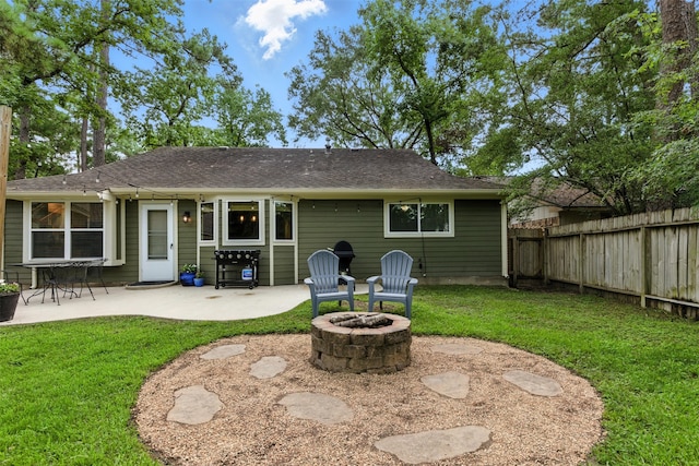 79 Fallshire Dr, The Woodlands, TX 77381 - back of property featuring a patio, a fire pit, and roof with shingles