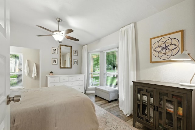 79 Fallshire Dr, The Woodlands, TX 77381 - bedroom featuring lofted ceiling, multiple windows, wood finished floors, and a ceiling fan