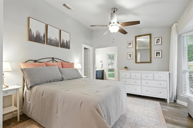 79 Fallshire Dr, The Woodlands, TX 77381 - bedroom with multiple windows, light wood-style flooring, vaulted ceiling, and ceiling fan