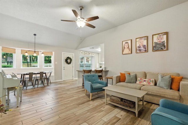 79 Fallshire Dr, The Woodlands, TX 77381 - living room with light wood finished floors, ceiling fan, and vaulted ceiling