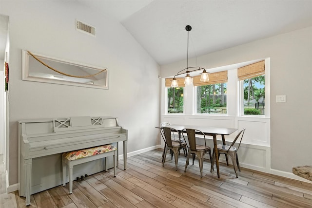 79 Fallshire Dr, The Woodlands, TX 77381 - dining area with vaulted ceiling and light wood-style flooring