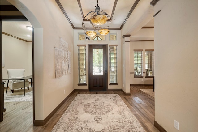 11399 Fm-3126, Livingston, TX 77351 - foyer featuring crown molding, wood finished floors, arched walkways, and a chandelier