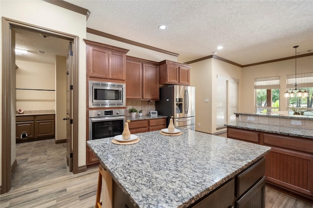 11399 Fm-3126, Livingston, TX 77351 - kitchen with stainless steel appliances, decorative backsplash, a center island, crown molding, and a textured ceiling