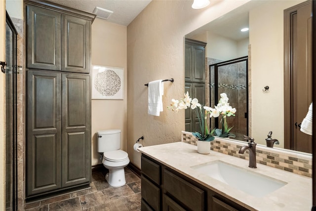 11399 Fm-3126, Livingston, TX 77351 - full bathroom with vanity, a shower stall, backsplash, stone finish flooring, and a textured wall