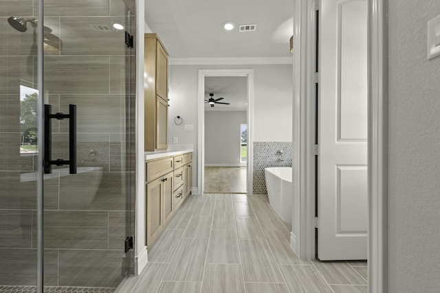 15408 Sandtrap Dr, Waller, TX 77484 - full bath with ornamental molding, vanity, a soaking tub, a shower stall, and a ceiling fan
