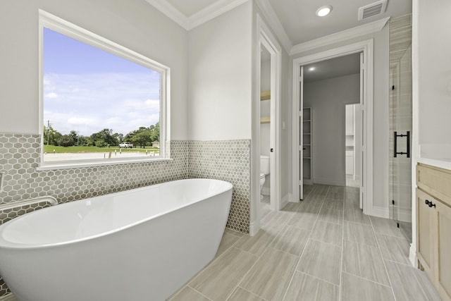 15408 Sandtrap Dr, Waller, TX 77484 - full bathroom with a freestanding tub, ornamental molding, tile walls, vanity, and recessed lighting