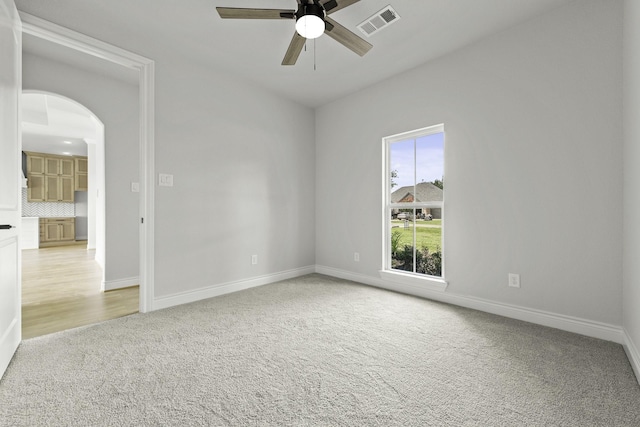 15408 Sandtrap Dr, Waller, TX 77484 - spare room with a ceiling fan, carpet flooring, and arched walkways