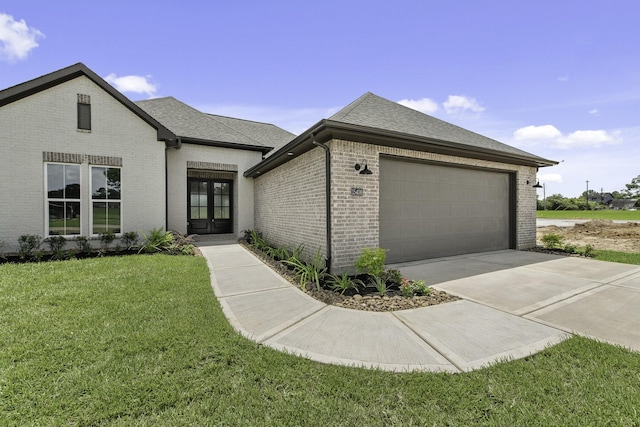 15408 Sandtrap Dr, Waller, TX 77484 - view of front of home with brick siding, french doors, a front lawn, a garage, and roof with shingles