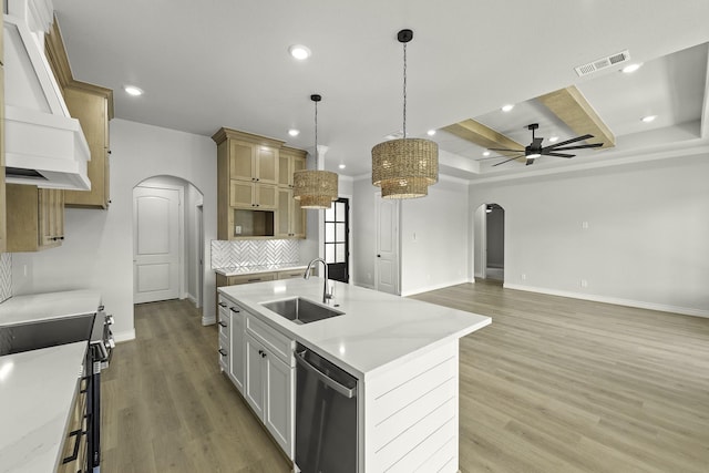 15408 Sandtrap Dr, Waller, TX 77484 - kitchen featuring arched walkways, stainless steel dishwasher, electric range, custom range hood, and recessed lighting