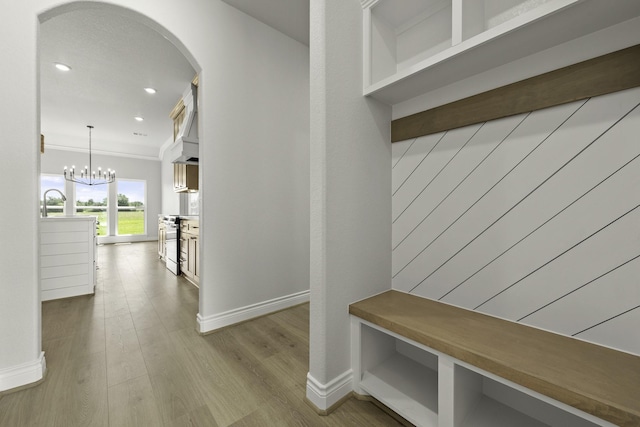 15408 Sandtrap Dr, Waller, TX 77484 - mudroom featuring arched walkways, wood finished floors, recessed lighting, and a chandelier
