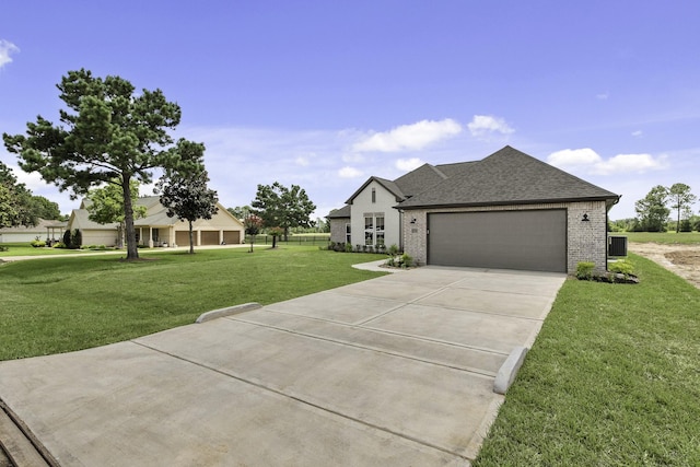 15408 Sandtrap Dr, Waller, TX 77484 - view of front of property featuring a front lawn, driveway, a garage, and brick siding
