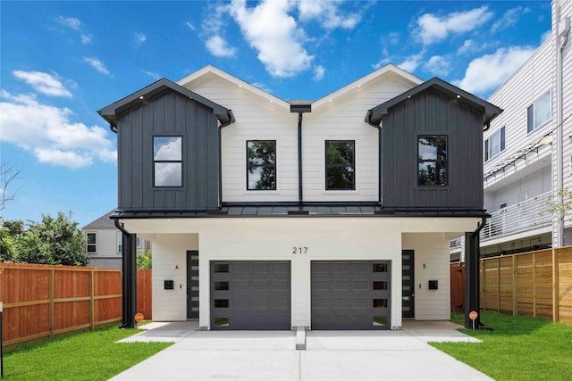 217 Pheasant St, Houston, TX 77018 - modern farmhouse featuring an attached garage, board and batten siding, a standing seam roof, and driveway