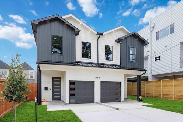 217 Pheasant St, Houston, TX 77018 - view of front of home featuring board and batten siding, an attached garage, driveway, a standing seam roof, and a metal roof