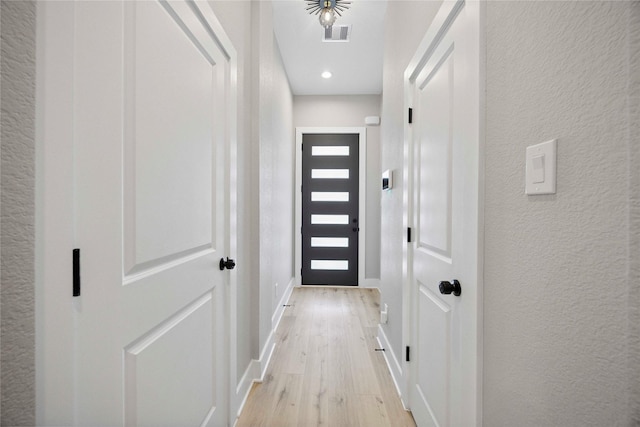 217 Pheasant St, Houston, TX 77018 - entryway featuring light wood-style flooring, a textured wall, and recessed lighting