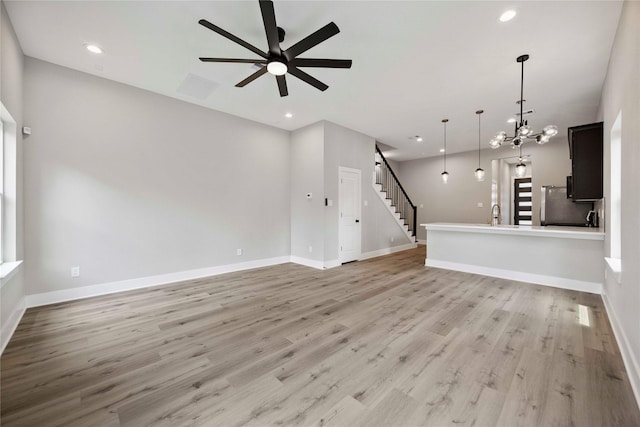 217 Pheasant St, Houston, TX 77018 - unfurnished living room featuring stairway, ceiling fan, light wood-type flooring, recessed lighting, and a chandelier