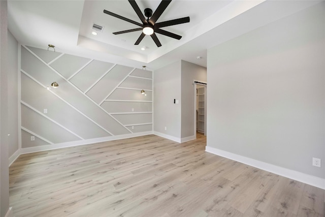 217 Pheasant St, Houston, TX 77018 - unfurnished room featuring a ceiling fan, light wood-style floors, a tray ceiling, and recessed lighting