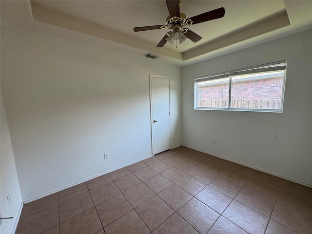 5518 Rio Ramos St, Rosharon, TX 77583 - empty room with a raised ceiling, ceiling fan, and tile patterned floors