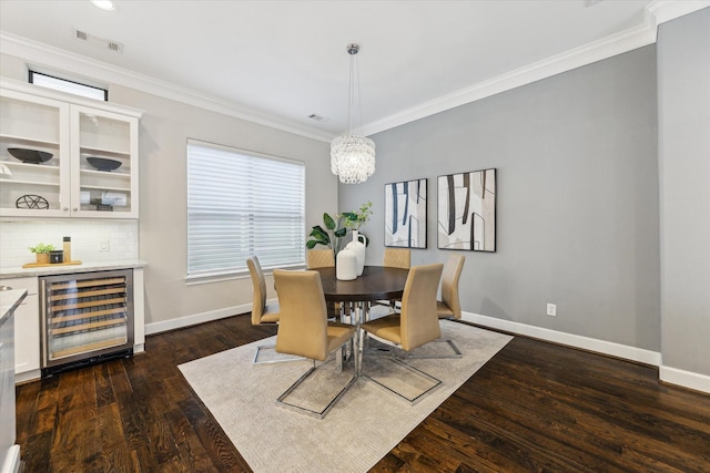 521 W Bell St, Houston, TX 77019 - dining area with wine cooler, dark wood finished floors, ornamental molding, a dry bar, and a chandelier