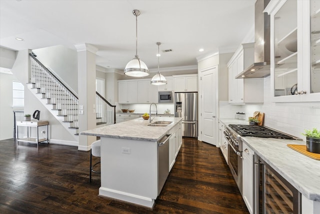 521 W Bell St, Houston, TX 77019 - kitchen with appliances with stainless steel finishes, wall chimney range hood, beverage cooler, crown molding, and tasteful backsplash