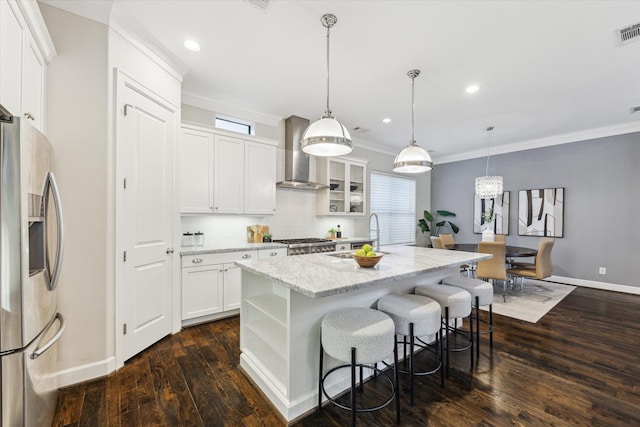 521 W Bell St, Houston, TX 77019 - kitchen with stainless steel fridge with ice dispenser, wall chimney exhaust hood, a kitchen island with sink, crown molding, and dark wood-style floors