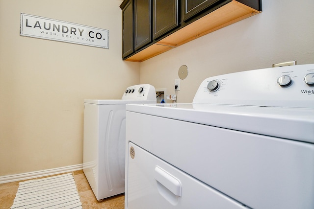 29011 Oldfield Ct, Katy, TX 77494 - washroom with cabinet space, separate washer and dryer, and light tile patterned flooring