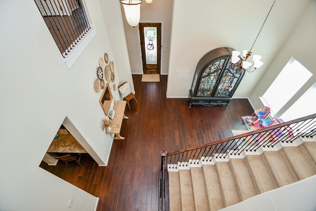 29011 Oldfield Ct, Katy, TX 77494 - stairs featuring healthy amount of natural light, a chandelier, a towering ceiling, and wood-type flooring