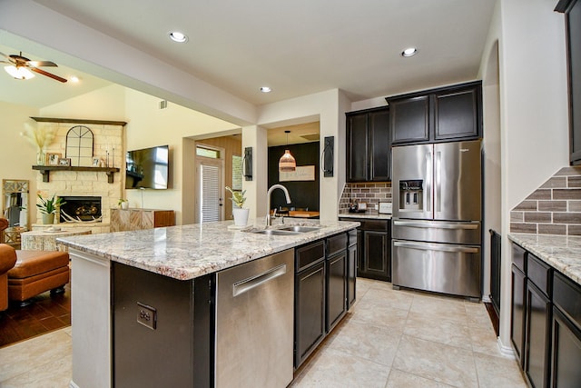29011 Oldfield Ct, Katy, TX 77494 - kitchen featuring appliances with stainless steel finishes, open floor plan, decorative backsplash, ceiling fan, and recessed lighting