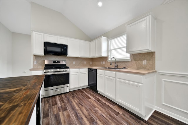 11703 Elizabeth Ct, Pinehurst, TX 77362 - kitchen with black appliances, butcher block countertops, lofted ceiling, dark wood-type flooring, and white cabinets