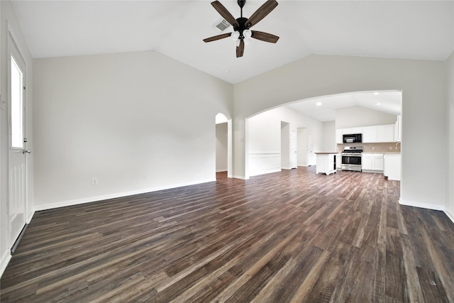 11703 Elizabeth Ct, Pinehurst, TX 77362 - unfurnished living room with vaulted ceiling, ceiling fan, dark wood-type flooring, and arched walkways